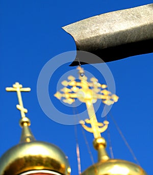 A drop falls from a gutter in Moscow in front of an Orthodox Church