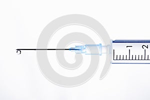 Drop of a liquid on a needle of a syringe