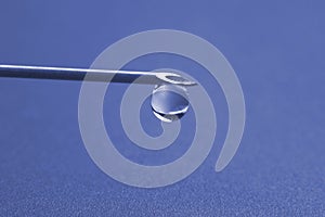 Drop of medicine on the tip of a medical injection needle