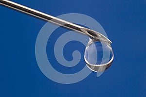 Drop of medicine on the tip of a medical injection needle