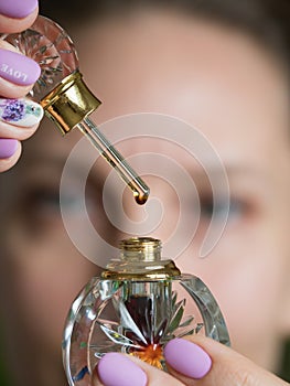 A drop of perfume on a glass stick.