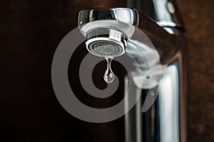 A drop of pure water dripped from the tap. photo