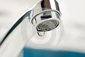 A drop of water drips from a leaky faucet