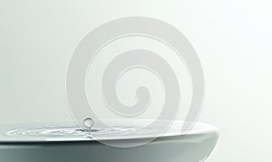 A drop of water is falling into a sink