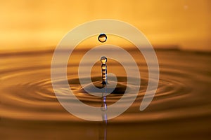 Drop of water splashing macro with ripples