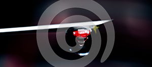 A drop of water on the tip of the needle from the syringe