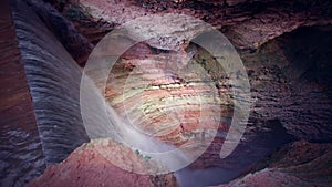 the drop of the waterfall in the canyon narrow and dark but colorful background