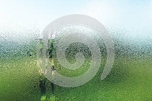 Droplets on glass in the morning with nature view