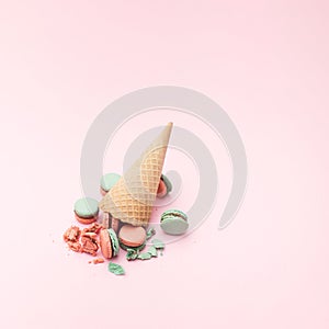 Dropped cornet with pink and light green crushed macarons. Pink background