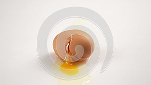 Dropped egg hitting a white background in the kitchen
