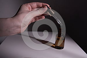 Dropper glass Bottle Mock-Up. Ð¡osmetic pipette on abstract background