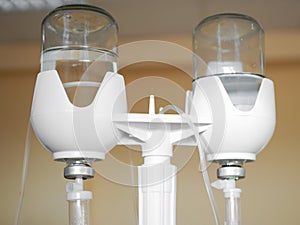 Dropper with saline. System with dropper and solution, closeup. Postoperative dropper