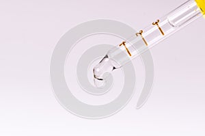 Dropper on a white and blue background. Equipment for chemical at the laboratory . Medicine, aromatherapy. Dropping pipet.