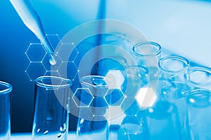 Dropping chemical liquid to test tube, laboratory research and development concept