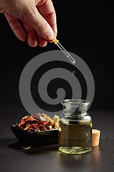 Dropping essential oil or herbal tincture into a small bottle