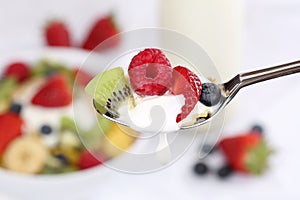 Dropping fruit yogurt on spoon for breakfast photo