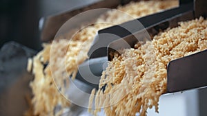 Dropping pasta from a conveyor belt at the macaroni manufactury