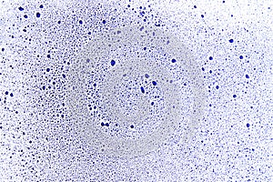 Drops of blue color on a white surface