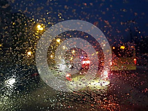 Drops on the car window -driving in the city during snowstorm