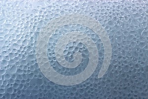 Drops of condensate on the surface of a plastic bottle, close-up