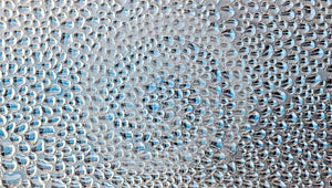 Drops of condensate on the surface of a plastic bottle, close-up