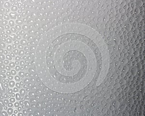 Drops of condensate on the surface of a plastic bottle, close-up