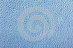 Drops of condensate on the surface of a plastic bottle, close-up