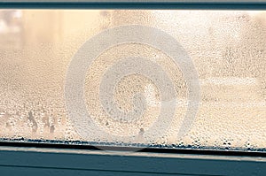 Drops of condensation on a metal-plastic window. Greenhouse effect