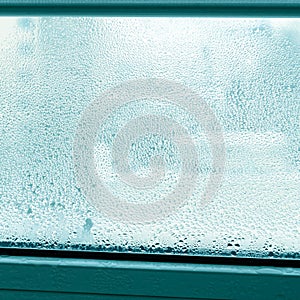 Drops of condensation on a metal-plastic window. Greenhouse effect