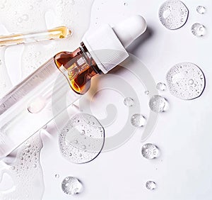 Drops of cosmetic serum and a pipette. A skin care product. White background. Copy space