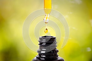 Drops from a dropper in a bottle. Isolated on a white background. Pharmacy and healthy background. Medicine. . photo