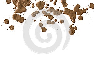 Drops of mud sprayed a white background