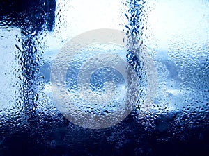 Drops of rain on blue glass background