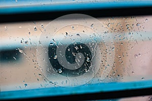 Drops of rain on blue glass background. drops on glass after rain for wallpaper. Drops on glass, window condensation.