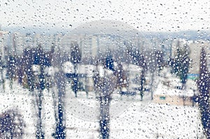 Drops of rain or sleet on the window in winter