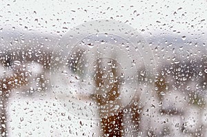 Drops of rain or sleet on the window in winter