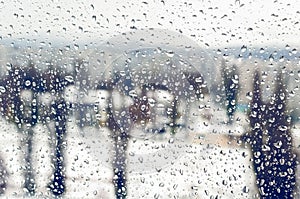 Drops of rain or sleet on the window in winter
