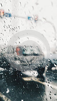 Drops of rain on the window car. View from car on road in the rainy day.