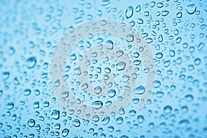 Drops of rain on the window glass. Shallow DOF. Window after rain. Blue Water background with water drops