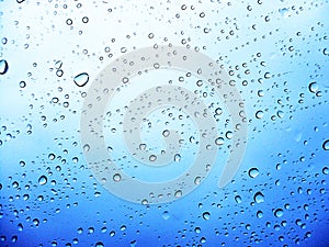 Drops on a transparent surface with a blue to white gradient background