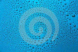 Drops of water on a color background. Light blue