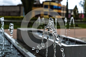 Drops of water before falling. Photograph of a fountain in a park