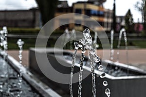 Drops of water before falling. Photograph of a fountain in a park