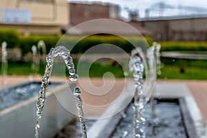 Drops of water before falling. Photograph of a fountain in a park