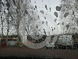 Drops of water and foam on the windshield of the car.