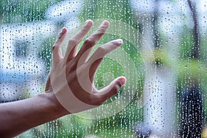 Drops of water on a glass and hand