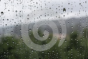 Drops of water on the glass on a rainy day, glass with drops of water