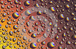 Drops of water on the glass, with the reflection of the rainbow