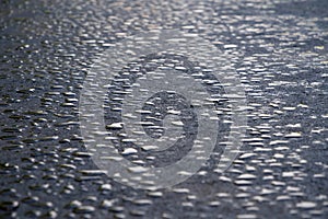 Drops of water lies on new asphalt road