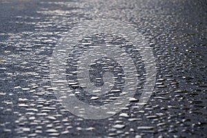 Drops of water lies on the new asphalt road